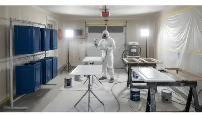Professional cabinet painting process in Reading MA showing smooth sprayed kitchen finish by local painters