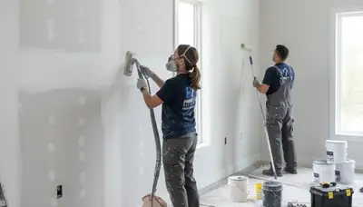 Painter repairing drywall cracks in Reading, MA home for seamless wall restoration